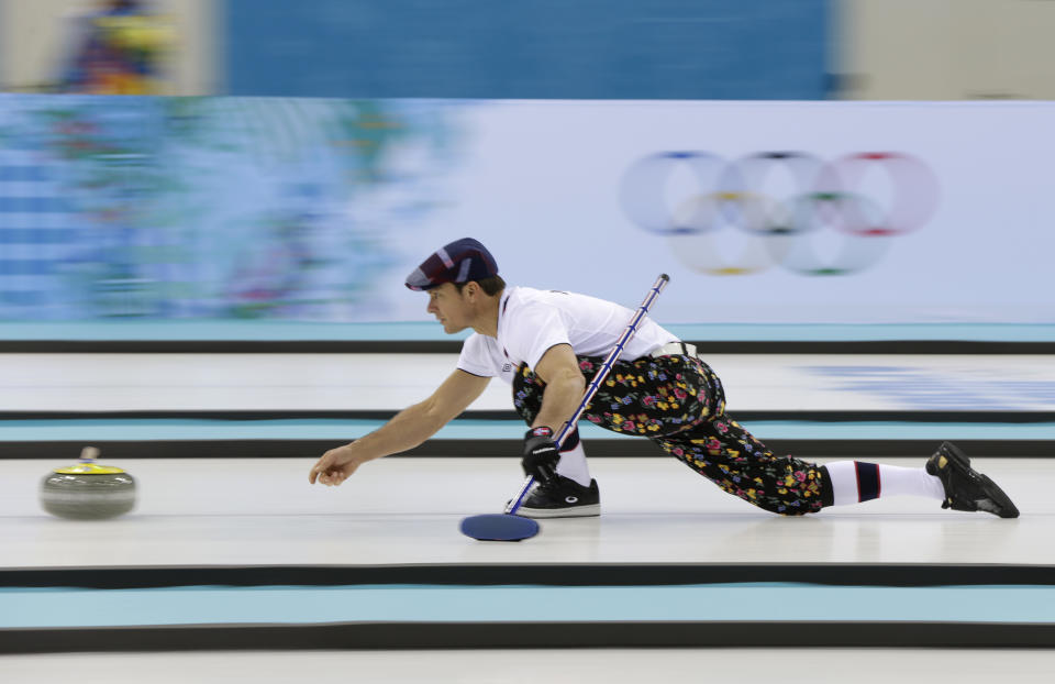 Norway skip Thomas Ulsrud, wearing rose-painting knickers and a patterned flat cap, delivers the stone during curling training at the 2014 Winter Olympics, Saturday, Feb. 8, 2014, in Sochi, Russia. (AP Photo/Robert F. Bukaty)