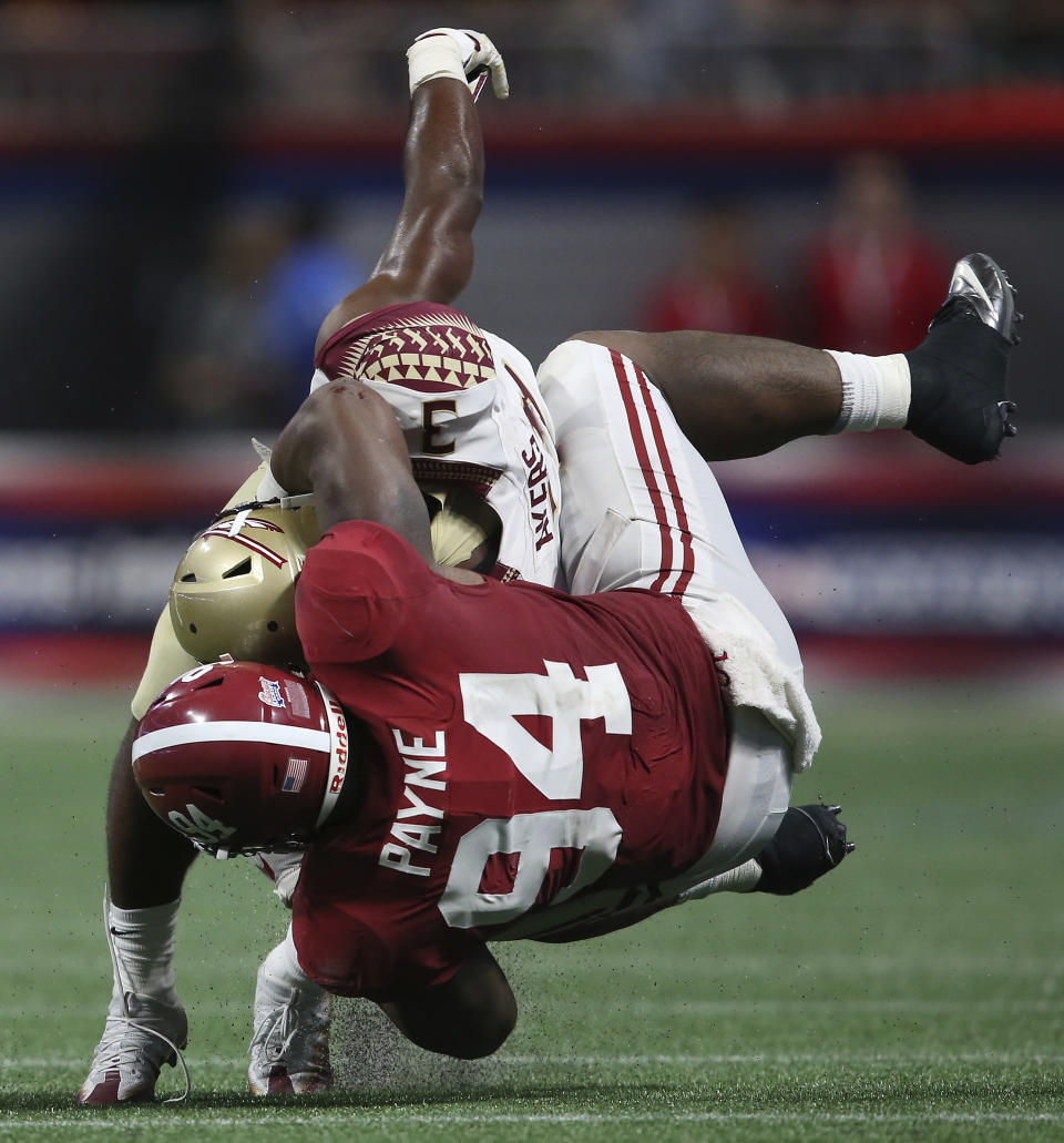 Alabama defensive lineman Da’Ron Payne (94) tackles Florida State running back Cam Akers (3) during the second half of an NCAA football game, Saturday, Sept. 2, 2017, in Atlanta. (AP Photo/John Bazemore)