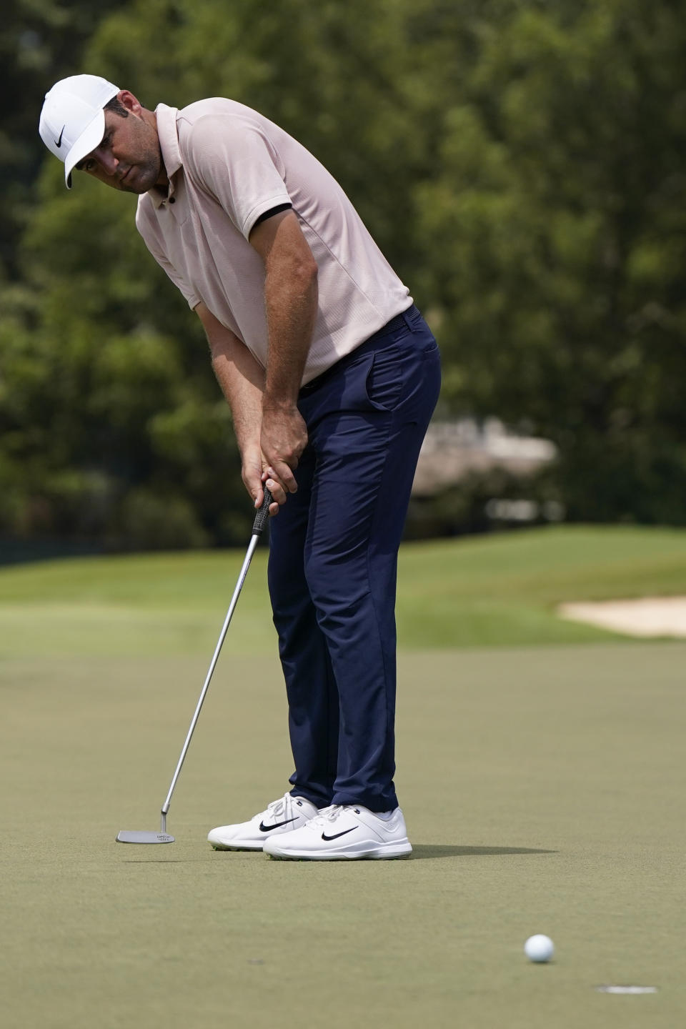 Scottie Scheffler putts on the first green during the third round of the Tour Championship golf tournament, Sunday, Aug. 27, 2023, in Atlanta. (AP Photo/Mike Stewart)