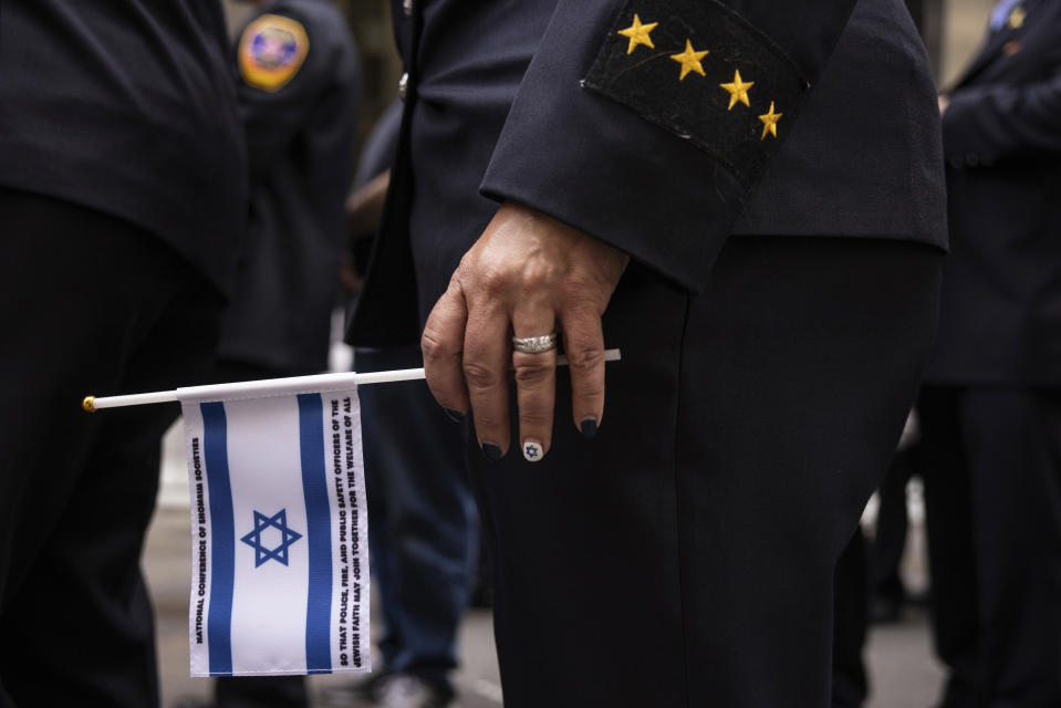A member of the New York City Fire Department holds an Israeli flag during the annual Israel Day Parade on Fifth Avenue on Sunday, June 2, 2024, in New York. (AP Photo/Yuki Iwamura)