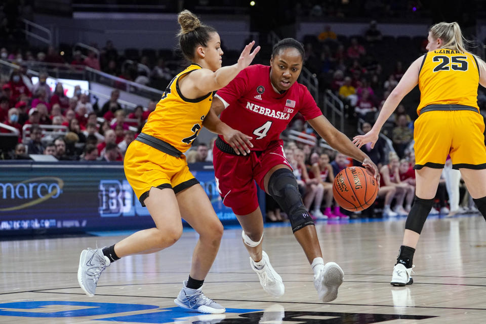 Nebraska guard Sam Haiby (4) drives on Iowa guard Gabbie Marshall (24) in the first half of an NCAA college basketball game at the Big Ten Conference tournament in Indianapolis, Saturday, March 5, 2022. (AP Photo/Michael Conroy)