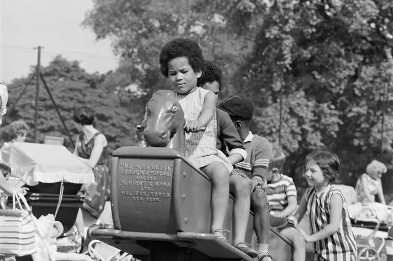 Children on a rocking horse, Clissold Park, Stoke Newington, London, 1962-1964. A row of four children riding on a many-seated rocking horse in the children's playground. (Photo by English Heritage/Heritage Images/Getty Images)