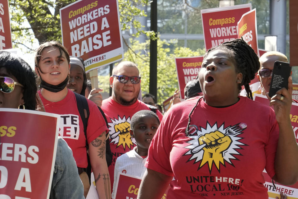 Workers who are contracted to feed World Bank employees through a firm called the Compass Group, protest for higher wages and affordable healthcare benefits, Wednesday, April 12, 2023, outside of the World Bank in Washington. (AP Photo/Mariam Zuhaib)