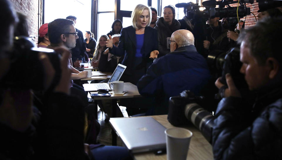 Sen. Kirsten Gillibrand, D-NY, talks with a patron as she is surrounded by reporters and photographers while visiting a coffee shop on Main Street in Concord, N.H., Friday, Feb. 15, 2019. Gillibrand visited New Hampshire as she explores a 2020 run for president. (AP Photo/Charles Krupa)