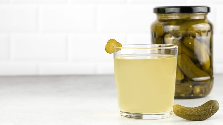 jar of pickles and glass of pickle juice