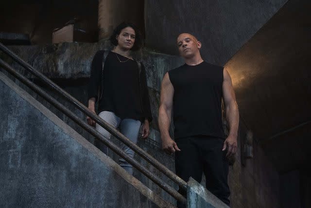 <p>Universal Pictures/Moviestore/Shutterstock </p> Michelle Rodriguez and Vin Diesel in 'F9: The Fast Saga'