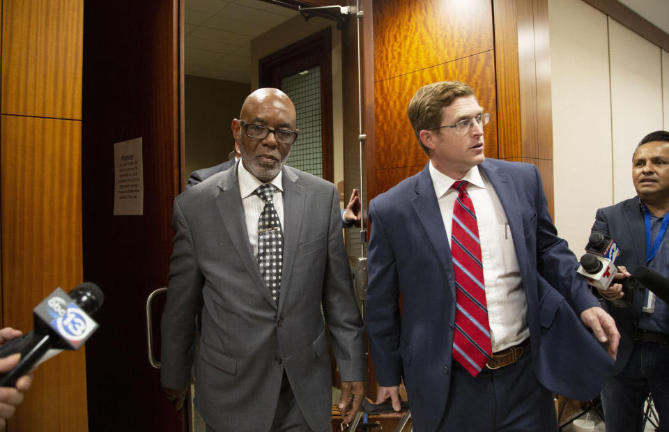 FILE - In this Jan. 9, 2020, file photo, Otis Mallet, center, exits the 338th District Criminal Court with his lawyer Jonathan Landers, right, in Houston. Prosecutors said Wednesday, Feb. 12, they believe Otis Mallet's brother, Steven Mallet, who was convicted based on what they allege is false testimony by an ex-Houston police officer whose cases are being reviewed following a 2019 deadly drug raid, is actually innocent. Earlier this month, Otis Mallet was declared innocent by a judge after his attorneys and prosecutors agreed that the ex-Houston police officer had lied during his trial about buying drugs from the brothers and had failed to provide evidence that would have helped their case. (Marie D. De Jesus/Houston Chronicle via AP, File)