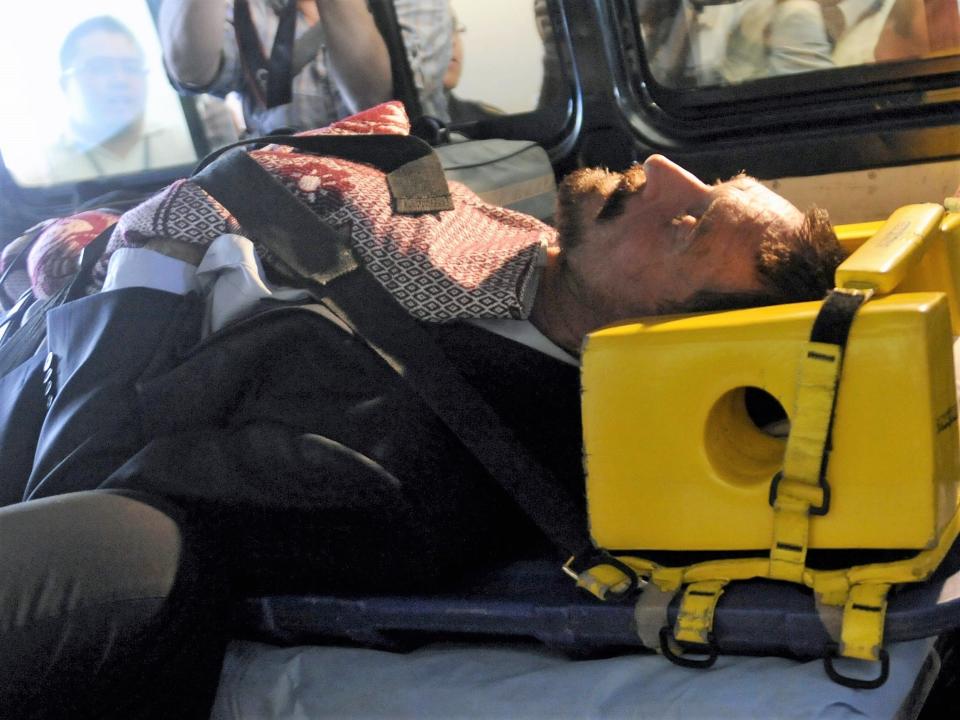 John McAfee is transferred in an ambulance to the national police hospital in Guatemala City on 6 December, 2012 (AFP via Getty Images)