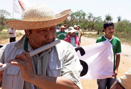 Adolfo Chavez plays a flute during the 10th Indigenous March to defend Mother Earth near San Jose