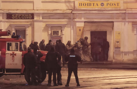 Members of a police special operations unit gather outside a post office, where a man took people hostage, in Kharkiv, Ukraine December 30, 2017. REUTERS/Stanislav Belousov