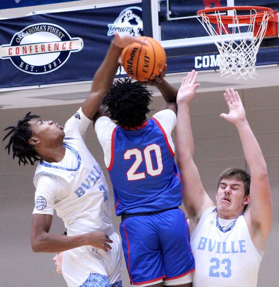 Bartlesville HIgh's Michael Smith III, left, pressures Millwood's Jaden Nickens, No. 20, while Bartlesville's Cooper Wood, right also squeezes down on defense during ConocoPhillips/Arvest Invitational play on Jan. 7, 2023.