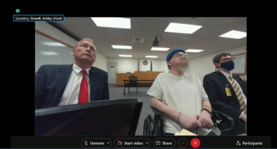 Idaho death row inmate Gerald Pizzuto, center, attends his clemency hearing on Tuesday, Nov. 30, 2021. Bruce Livingston, left, one of Pizzuto’s attorneys with the nonprofit Federal Defender Services of Idaho, sits at his left, with other members of his team also on hand.