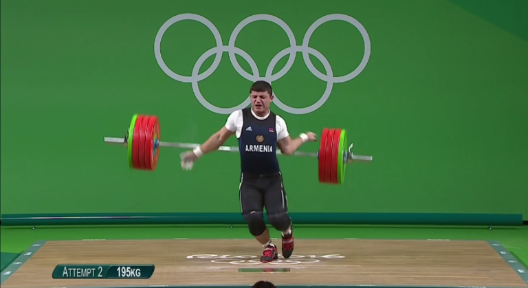 Armenian weightlifter Andranik Karapetyan’s elbow explodes as he attempts to lift 430 pounds for the bronze medal.