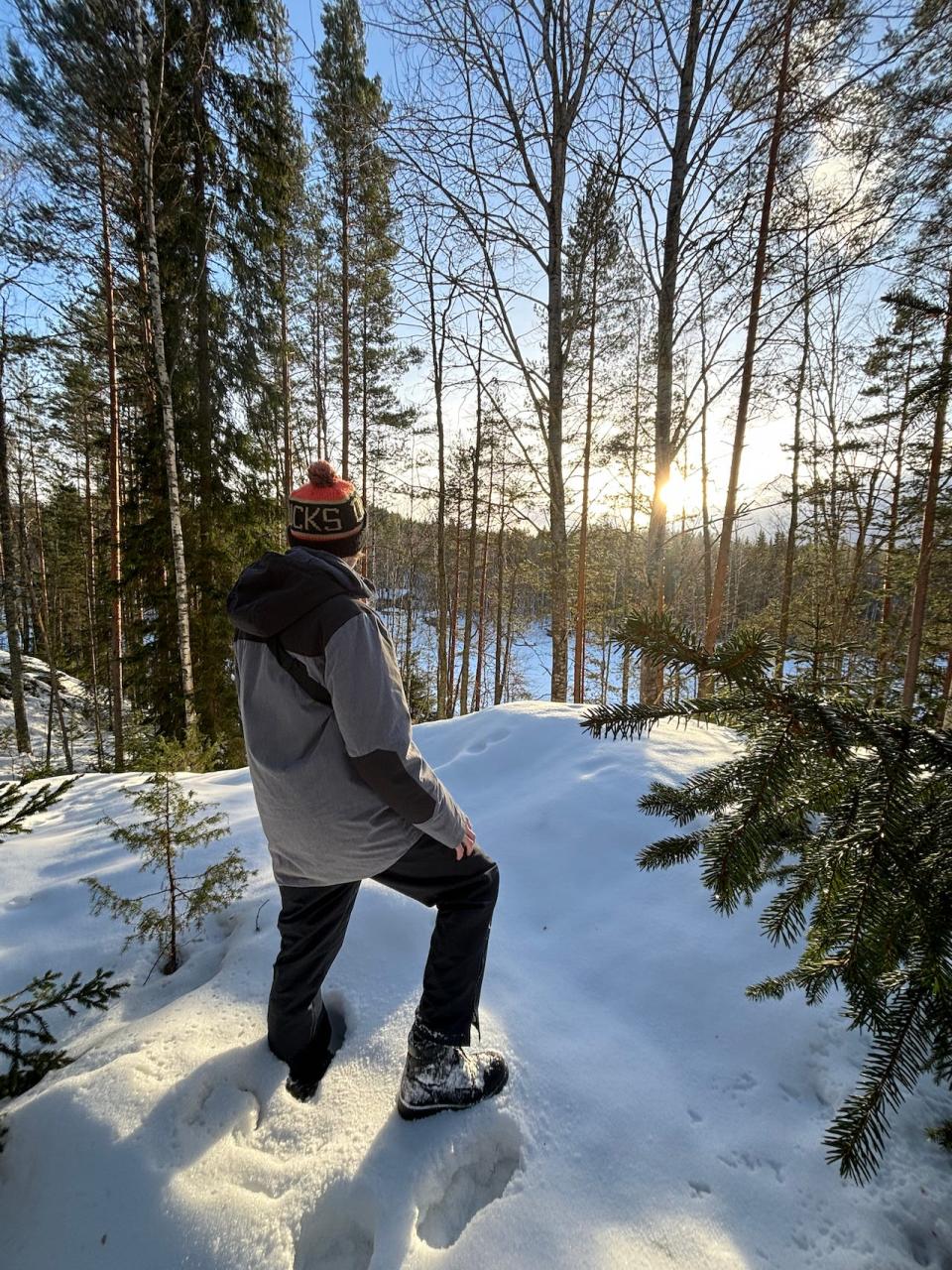 Oliver Russell standing on a snow-capped hill on his private island.