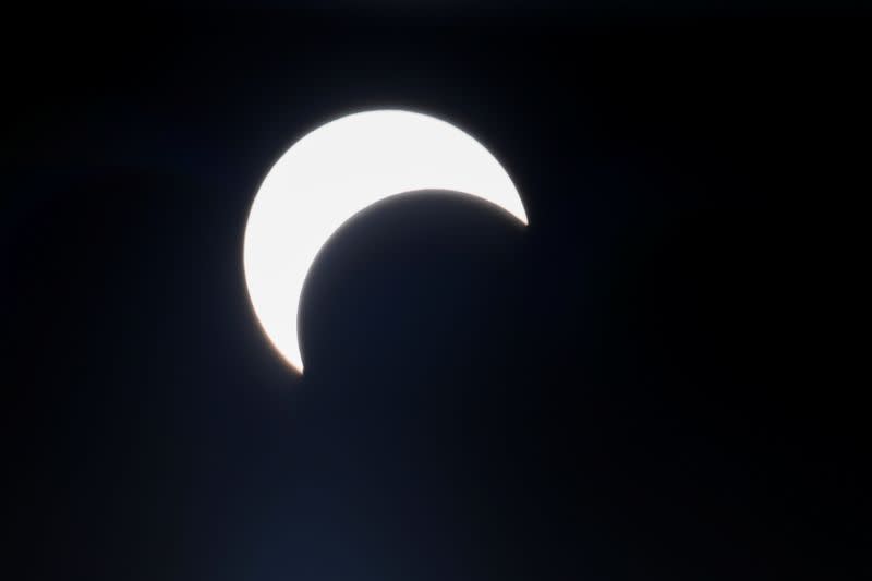 A partial solar eclipse is pictured along Clifton beach in Karachi