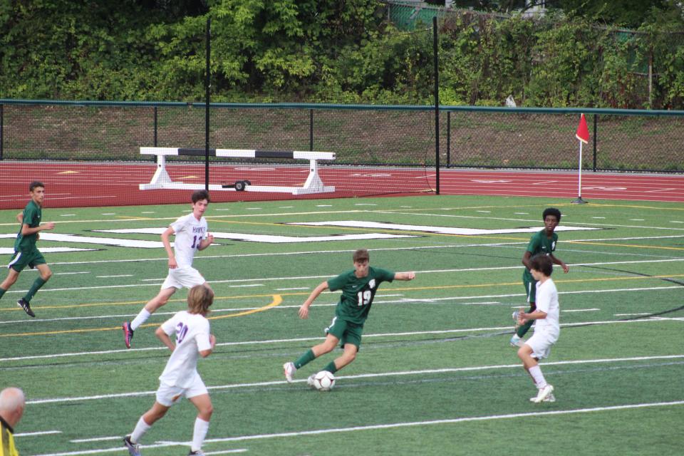 Spackenkill's Dylan Updike maneuvers between Rhinebeck defenders during a fall 2022 boys soccer game.