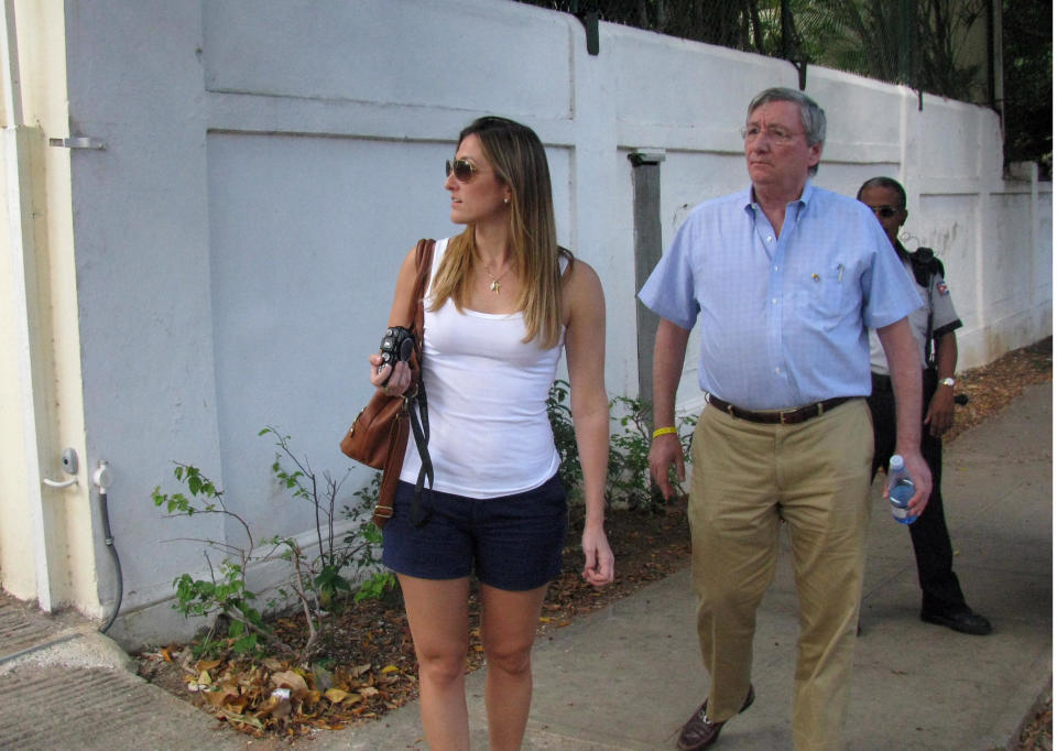 Cuban exile Sergio Dalmau, right, walks on the sidewalk with his daughter Cecilia as they search for the childhood home of his ex-wife, Cecilia's mother, in the Miramar suburb in Havana, Cuba, Tuesday March 27, 2012. Dalmau left Cuba 51 years ago Thursday as part of the so-called "Pedro Pan flights" organized by the Roman Catholic Church to help spirit Cuban children off the island in the early 1960s. The two are part of a delegation of more than 300 mostly Cuban-American pilgrims visiting the island in honor of Pope Bennedict XVI’s visit. (AP Photo/Laura Wides-Munoz)