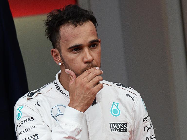 Mercedes' British driver Lewis Hamilton ponders his third place the podium at the Monaco Grand Prix on May 24, 2015