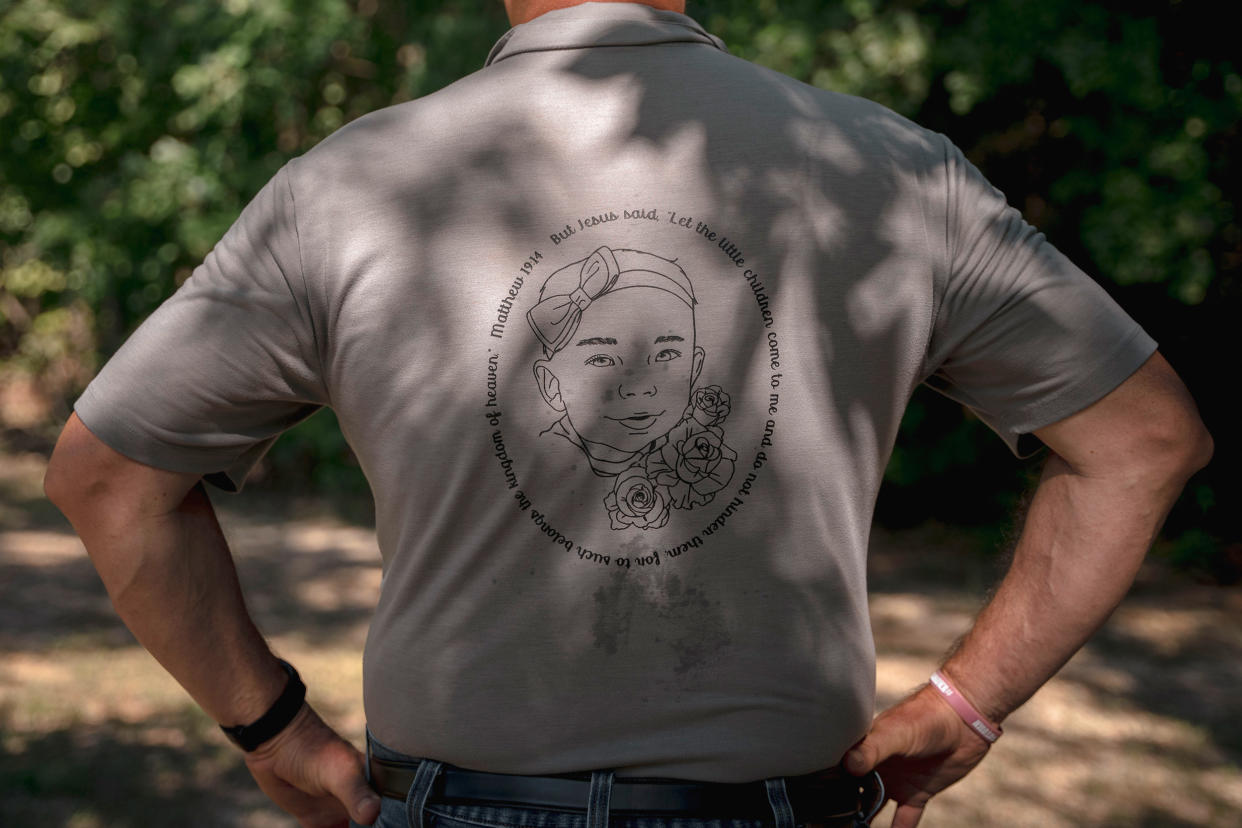 The back of a t-shirt worn by Autumn Wells' grandfather, Joel Wells, at the family burial plot. The shirt has a image of Autumn's face with a bible quote surrounding it. (Andrea Morales for NBC News)