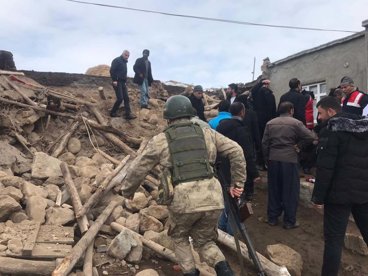 Teams inspect the wreckage of a mud-brick construction after tremors from a 5.7-magnitude quake centered in northwestern Iran were also felt in Turkey's Van province: Anadolu Agency via Getty Images