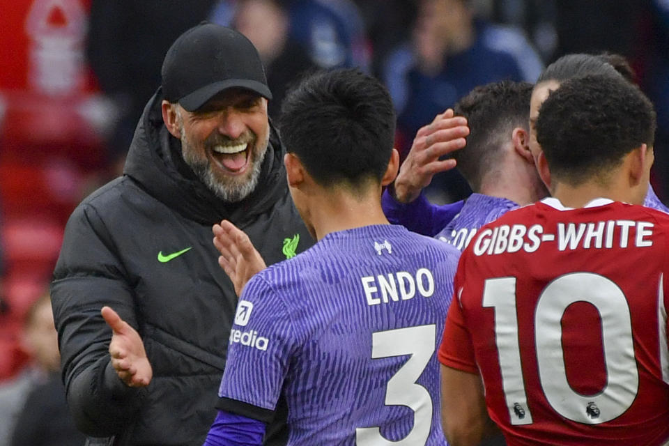 Liverpool's manager Jurgen Klopp, left, and Liverpool's Wataru Endo celebrate at the end of the English Premier League soccer match between Nottingham Forest and Liverpool at City ground in Nottingham, England, Saturday, March 2, 2024. (AP Photo/Rui Vieira)