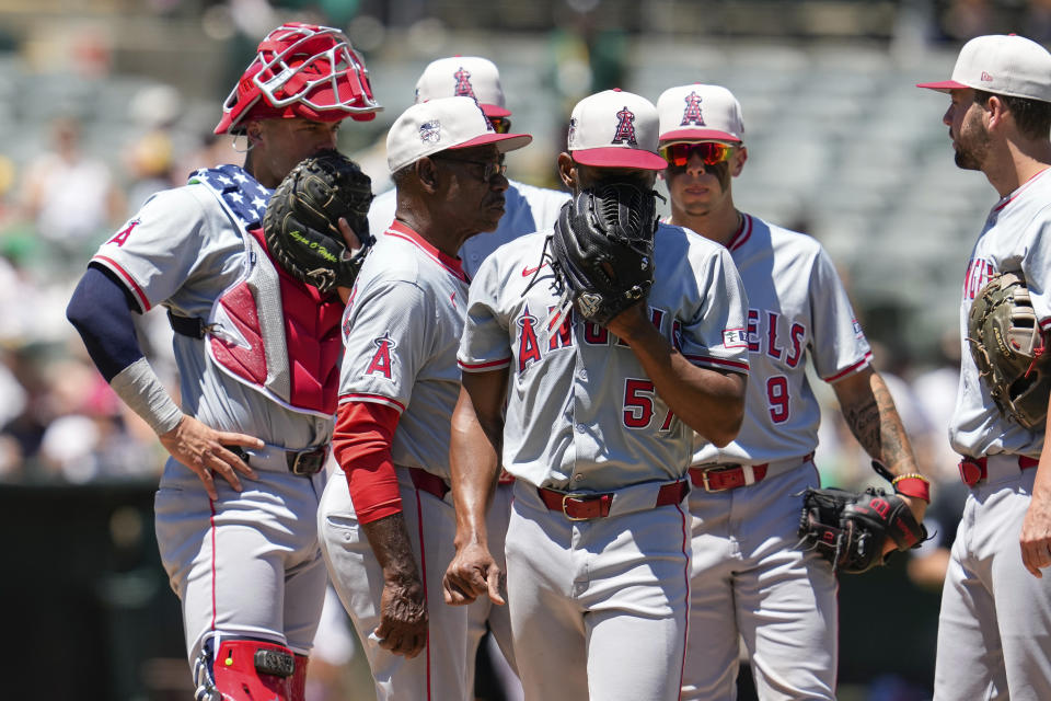 Los Angeles Angels pitcher Roansy Contreras, center, exits during the third inning of a baseball game against the Oakland Athletics, Thursday, July 4, 2024, in Oakland, Calif. (AP Photo/Godofredo A. Vásquez)