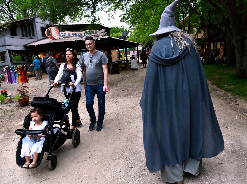 Dressed as the wizard Gandalf from “The Lord of the Rings,” Bill Block of Fort Worth walks past a family.