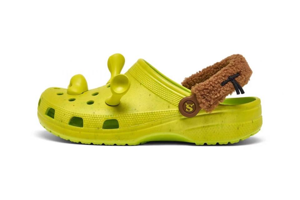 A profile image of a Shrek Croc that is bright green with brown straps