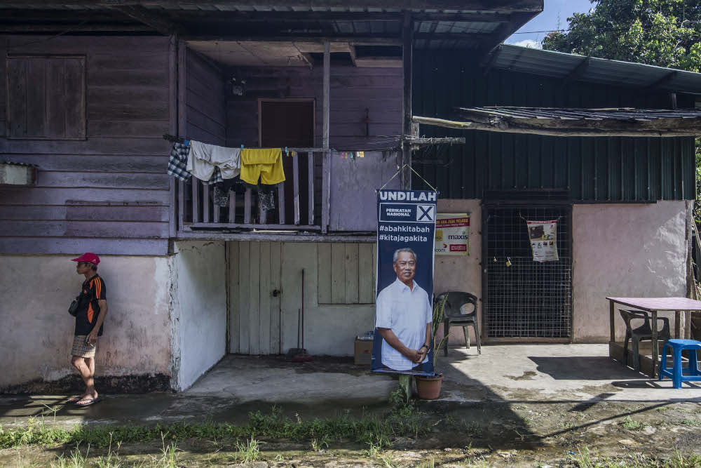 An election poster featuring Perikatan Nasional chairman Tan Sri Muhyiddin Yassin is seen in Moyog, Sabah September 21, 2020. — Picture by Firdaus Latif