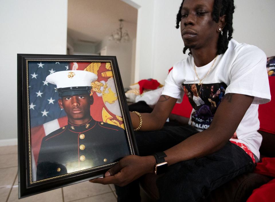 Jalen Richardson holds a photo on Tuesday, July 12, 2022 of his cousin Malique Richardson, a 24-year-old former Marine who was killed last week in Tallahassee, Fla. 