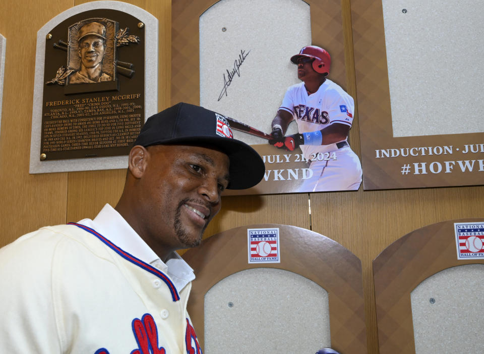 Newly elected Baseball Hall of Fame inductee Adrián Beltré poses for a photograph after signing his name to the backer board of his plaque during a news conference Thursday, Jan. 25, 2024, in Cooperstown, N.Y. (AP Photo/Hans Pennink)