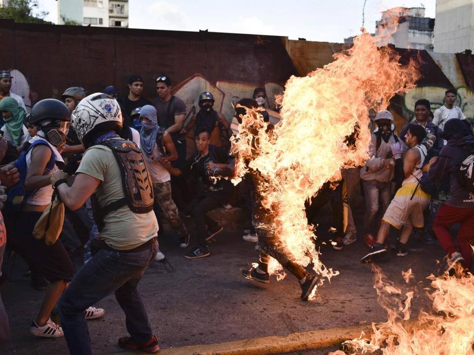 Opposition demonstrators set on fire Orlando Figuera during a protest against the government of President Nicolas Maduro in Caraca (CARLOS BECERRA/AFP/Getty Images)