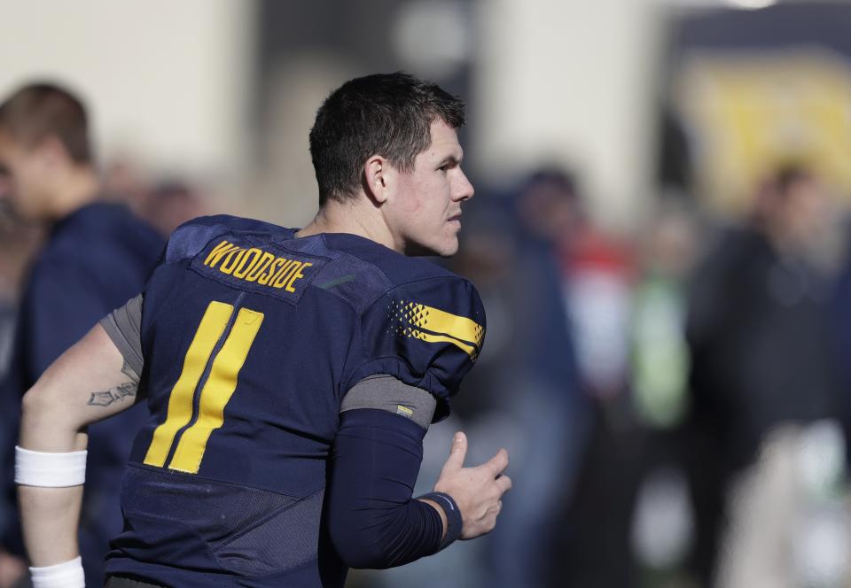 Toledo quarterback Logan Woodside runs in the bench area during the first half of an NCAA college football game against Western Michigan, Friday, Nov. 24, 2017, in Toledo, Ohio. (AP Photo/Carlos Osorio)