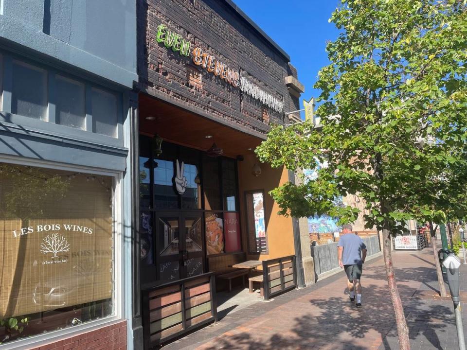 A man walks past the former Even Stevens sandwich shop in Boise, which advertises Nara Ramen in the windows.