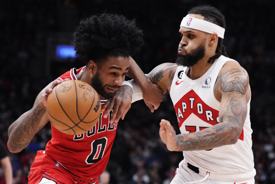 Chicago Bulls guard Coby White (0) tries to get past Toronto Raptors guard Gary Trent Jr. (33) during the first half of an NBA basketball game Tuesday, Feb. 28, 2023, in Toronto. (Frank Gunn/The Canadian Press via AP)