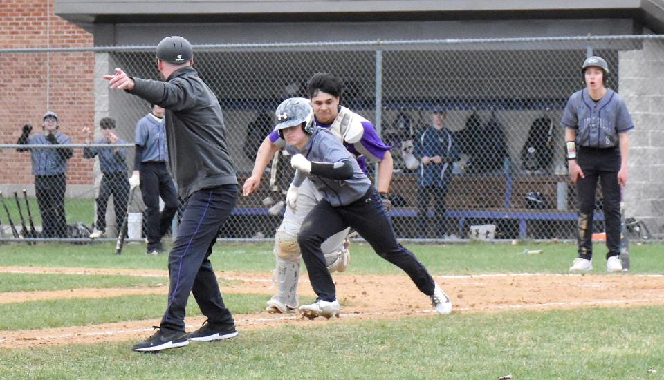 West Canada Valley catcher Dylan Dayton chases Little Falls Mountie Braden McCumber back toward third base with Little Falls coach Bob Gollegly (left) pointing the way during the seventh inning Monday.