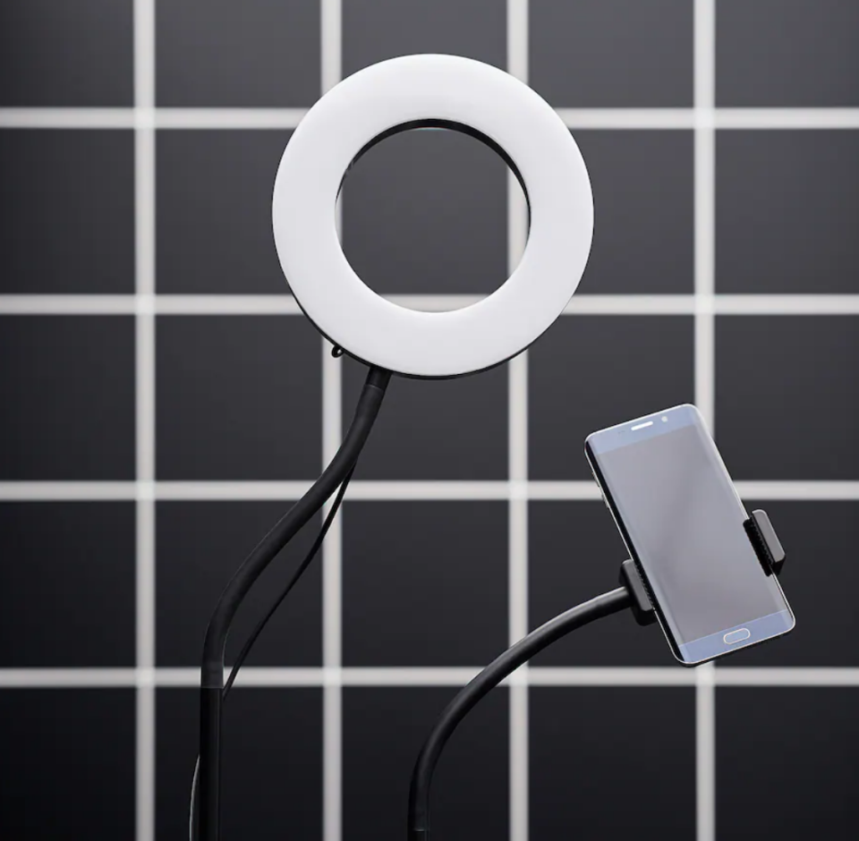 A close-up look at an IKEA desktop ring lamp with a builtin phone holder.