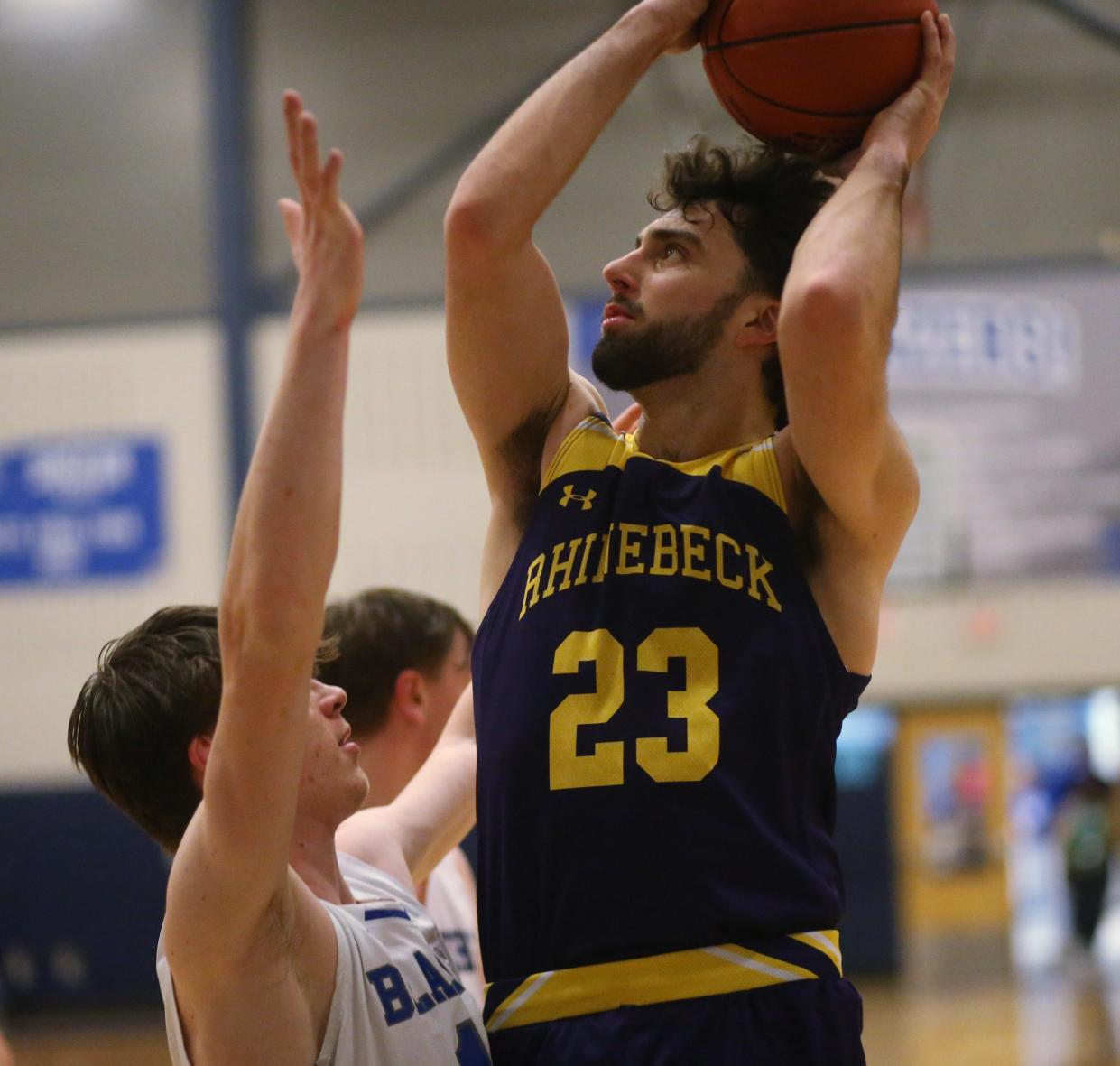 Rhinebeck's Griffin Giles takes a shot over Millbrook's Hunter Williamson during a boys basketball game on February 9, 2024.