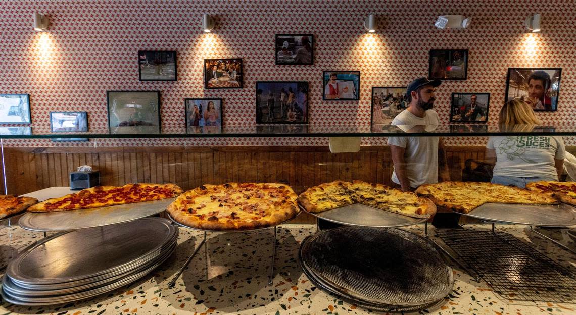 One wall inside Far Out Pizza is devoted to movie scenes in which a character is eating pizza.