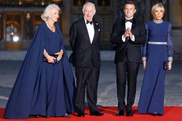 <p>LUDOVIC MARIN/AFP via Getty </p> Queen Camilla, King Charles, French President Emmanuel Macron and his wife Brigitte Macron arrive at the state banquet at the Palace of Versailles on Sept. 20