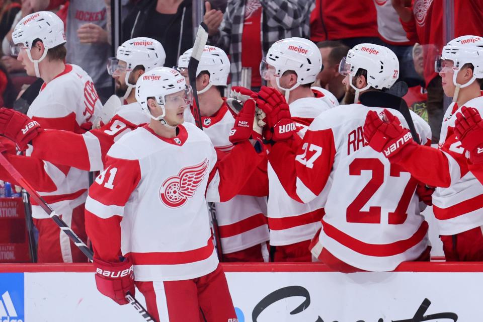 Dominik Kubalik (81) of the Detroit Red Wings high-fives his teammates after scoring a goal against the Chicago Blackhawks during the second period at United Center in Chicago on Friday, Oct. 21, 2022.