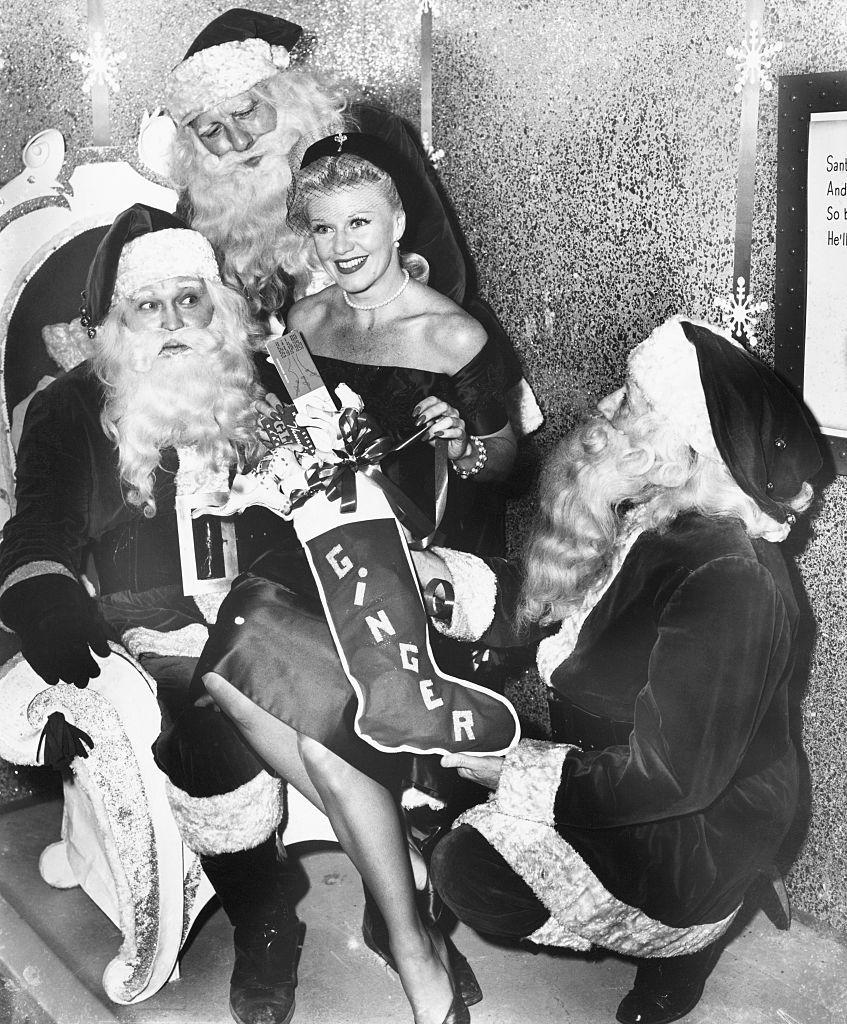 <p>Judging by how many Santas are gathered around actress Ginger Rogers, we'd say she was nice that year. </p>