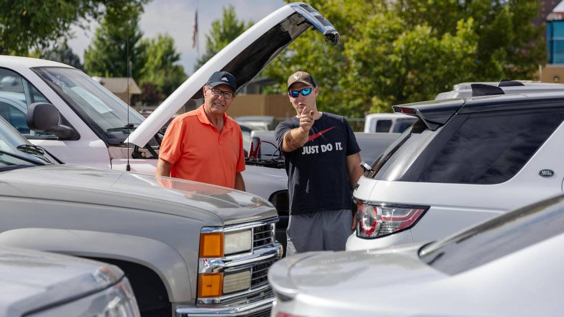 Ken Heninger, left, and son Mike check out vehicles at Musick Auction in Meridian on Saturday.