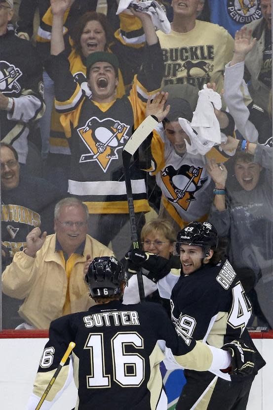 Pittsburgh Penguins' Brian Gibbons (49) celebrates his second goal of the first period with teammate Brandon Sutter (16) during a first-round NHL playoff hockey game against the Columbus Blue Jackets in Pittsburgh on Saturday, April 19, 2014. (AP Photo/Gene J. Puskar)