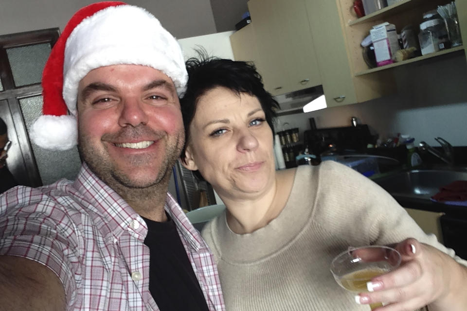 In this image provided by Johnathan Walton, Walton and Marianne "Mair" Smyth pose for a selfie in December 2013, at her tree trimming Christmas party in downtown Los Angeles. Smyth is in a Maine jail awaiting a hearing in April 2024 that will decide whether she can be extradited to the United Kingdom over a scam dating back more than 15 years in Northern Ireland. She is accused of stealing more than $170,000 from at least five victims from 2008 to 2010 in Northern Ireland, according to court records. (Johnathan Walton via AP)