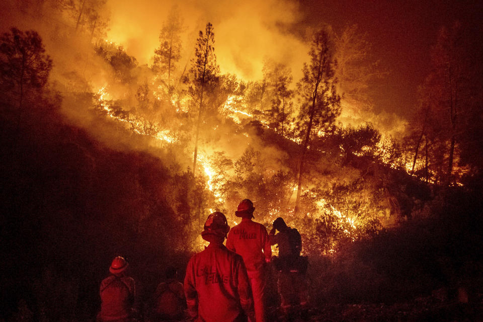 FILE - In this Aug. 7, 2018 file photo, firefighters monitor a backfire while battling the Ranch Fire, part of the Mendocino Complex Fire near Ladoga, Calif. Nearly two years ago President Trump ordered the U.S. Forest Service and the Department of Interior to make federal lands less susceptible to catastrophic wildfires. But the agencies fell short of his goals in 2019, treating a combined 4.3 million acres — just over half of the 8.45 million acres the president sought. It was only slightly better than their average annual performance over nearly two decades, according to government data. (AP Photo/Noah Berger, File)