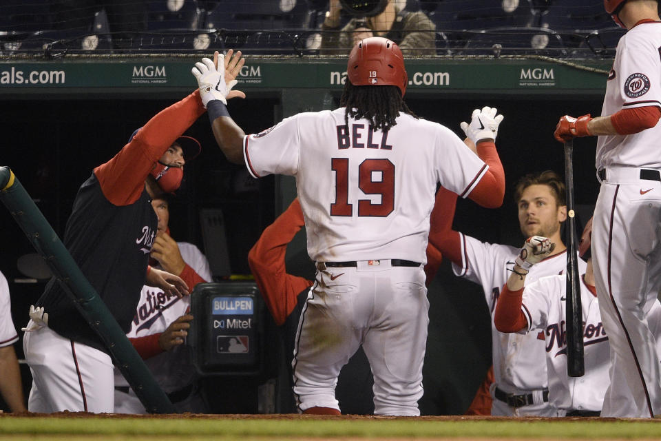 Washington Nationals' Josh Bell (19) returns to the dugout after hitting a home run during the sixth inning of the team's baseball game against the St. Louis Cardinals, Tuesday, April 20, 2021, in Washington. (AP Photo/Nick Wass)