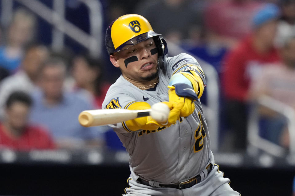 Milwaukee Brewers' William Contreras hits an RBI single to score Blake Perkins during the sixth inning of a baseball game against the Miami Marlins, Saturday, Sept. 23, 2023, in Miami. (AP Photo/Lynne Sladky)