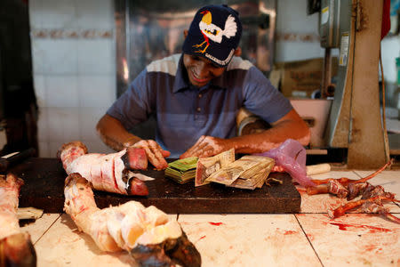 Stacks of Venezuelan bolivar notes are seen in a butchery at Las Pulgas market in Maracaibo, Venezuela July 26, 2018. REUTERS/Marco Bello