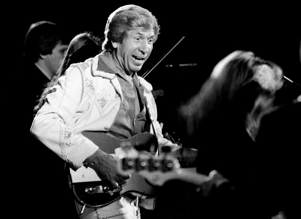 Buck Owens, center, performs for the International Fan Club organization banquet and show during Fan Fair at Municipal Auditorium on June 8, 1977. One of his biggest hits is 